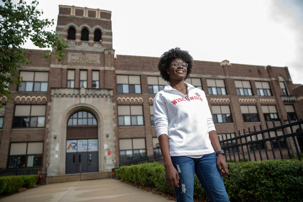 Sarah Akakpo stands in front of her high school