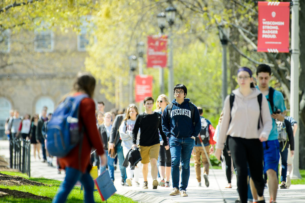Students walk down the sidewalk of Bascom Hill during spring at the University of Wisconsin-Madison