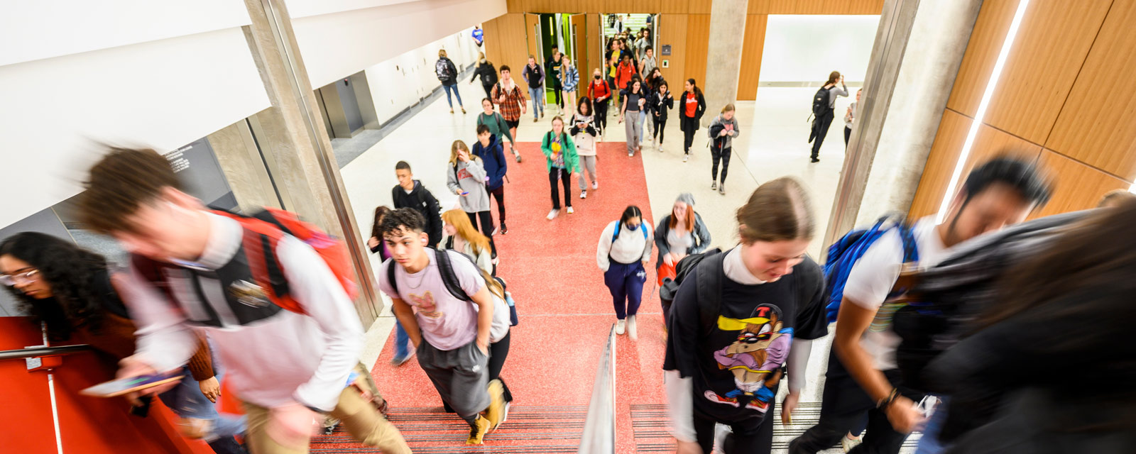 Students flow out of lecture hall and walk up the red and white marble terrazzo stairs in the new instructional tower addition to the Chemistry Building at the University of Wisconsin–Madison